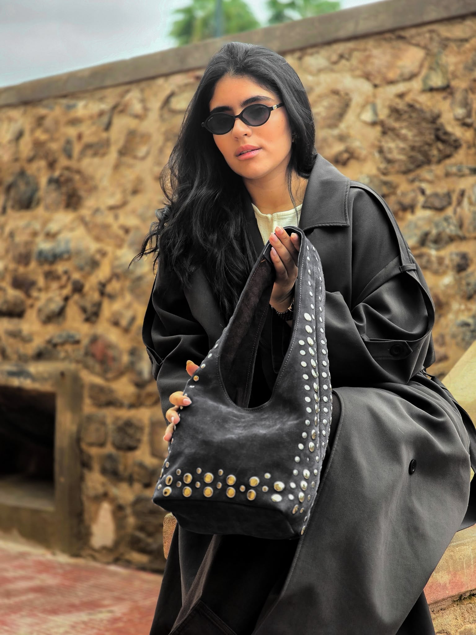 Woman holding a MARQEVEN leather bag in a lifestyle setting